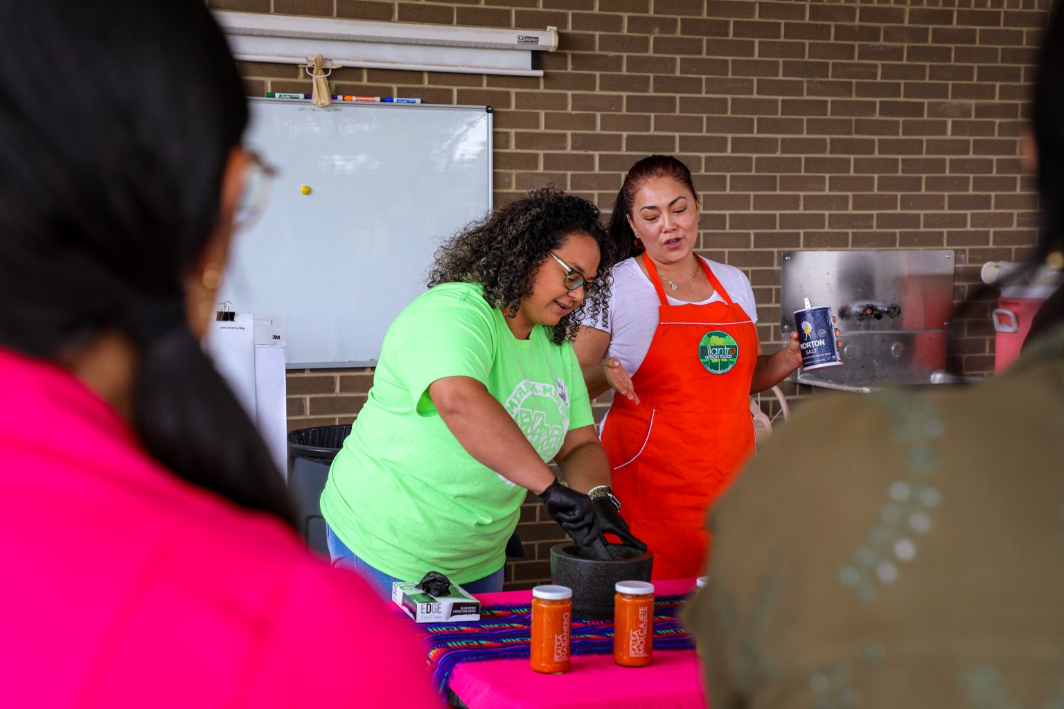 Participant helps make salsa.