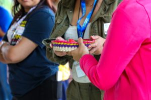 women pass a bowl of peppers around